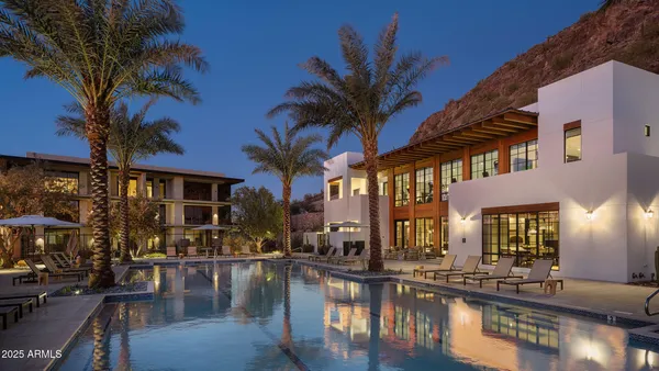 a view of a house with swimming pool and sitting area