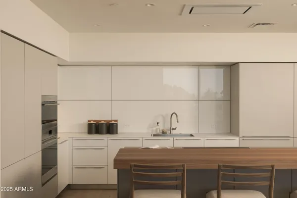 a kitchen with a sink a table and chairs
