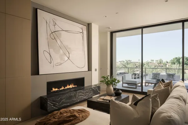 a living room with furniture large window and a lamp