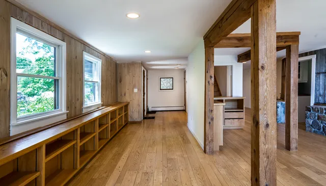 a view of hallway with wooden floor and stairs