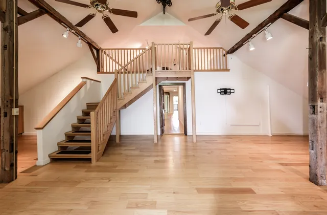 a view of entryway and hall with wooden floor