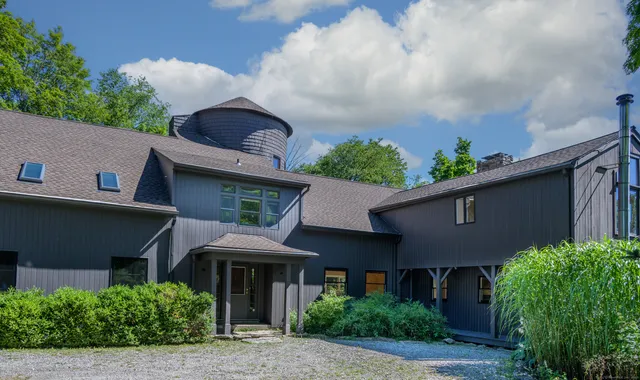 a front view of a house with plants