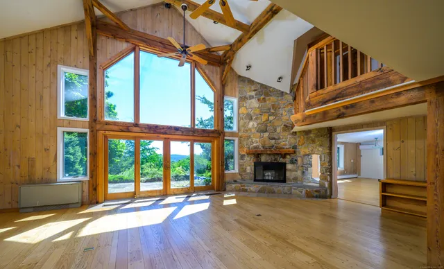 a view of living room with furniture and fireplace