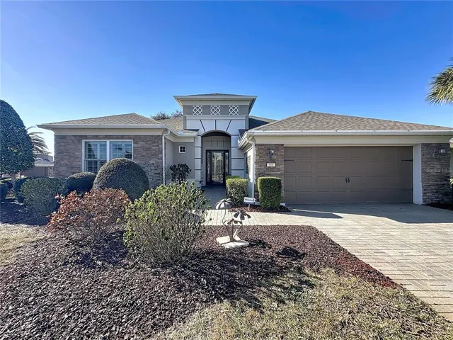 a living room with furniture a rug and a chandelier