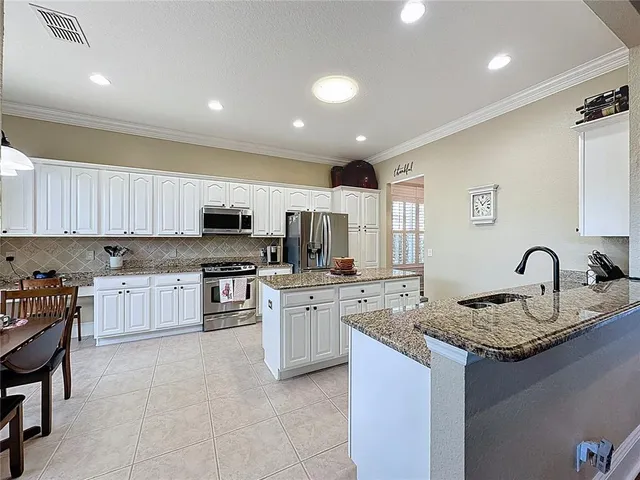 a view of a dining room with furniture wooden floor and a chandelier