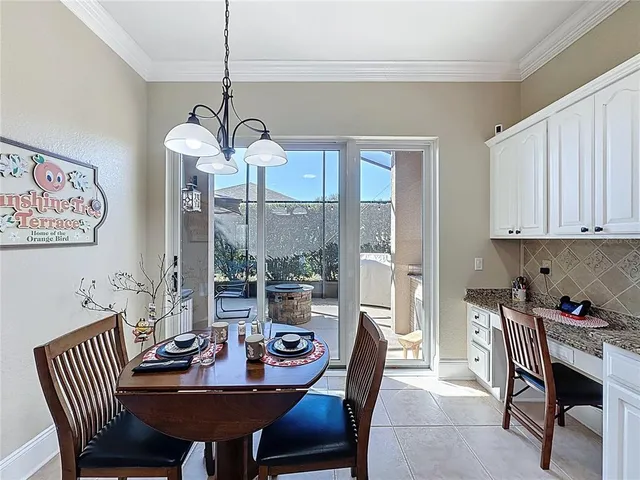 a kitchen with stainless steel appliances kitchen island granite countertop a stove a sink a dining table and chairs with wooden floor