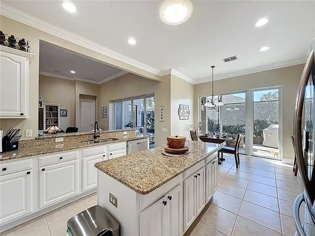 a view of a dining room with furniture a chandelier and wooden floor