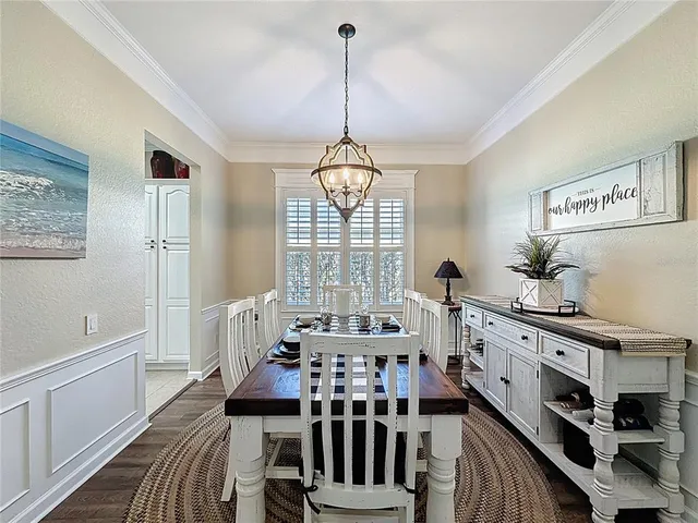 a view of a dining room with furniture wooden floor and a chandelier