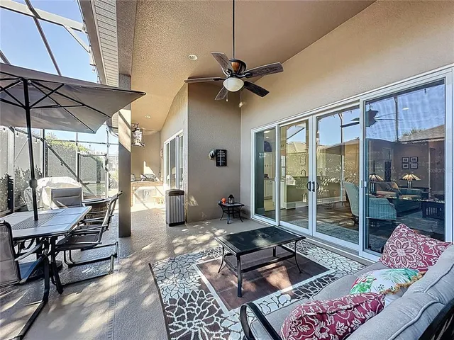 a living room with furniture a window and a chandelier