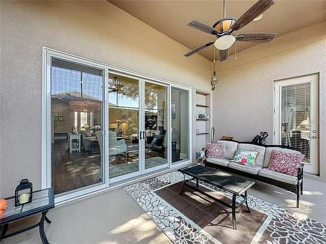 a bedroom with a large bed and a flat tv screen on dresser