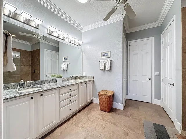 a bedroom with a bed and a ceiling fan