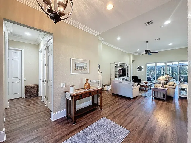 a living room with furniture ceiling fan and a rug