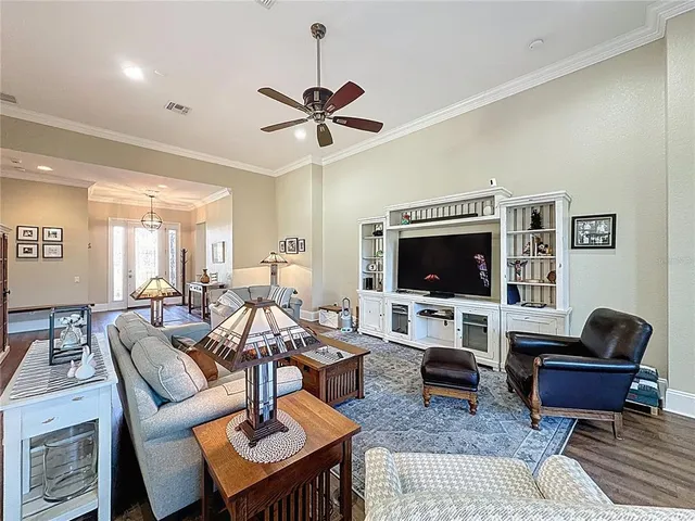 a kitchen with stainless steel appliances granite countertop a stove top oven a sink dishwasher a dining table and chairs with wooden floor