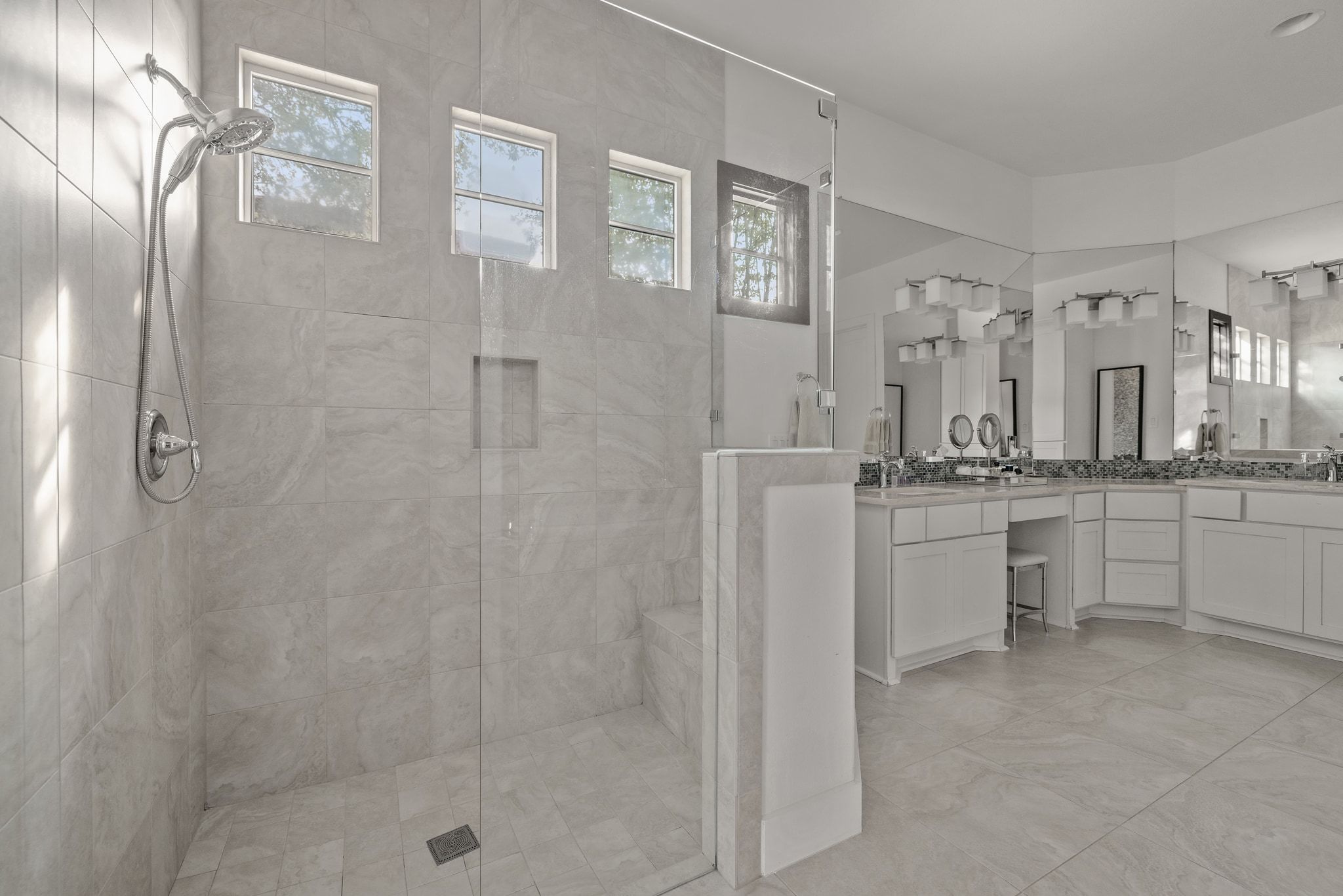 4720 Rockcliff Road, Unit 1 Austin, TX 78746 - Photo 24 of 39 A generously sized, naturally illuminated primary bathroom offers a spacious walk-in shower and abundant vanity space.