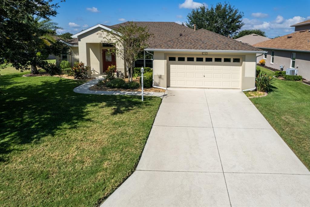27401 Pine Straw Road Leesburg, FL 34748 - Photo 1 of 1 a front view of a house with garden