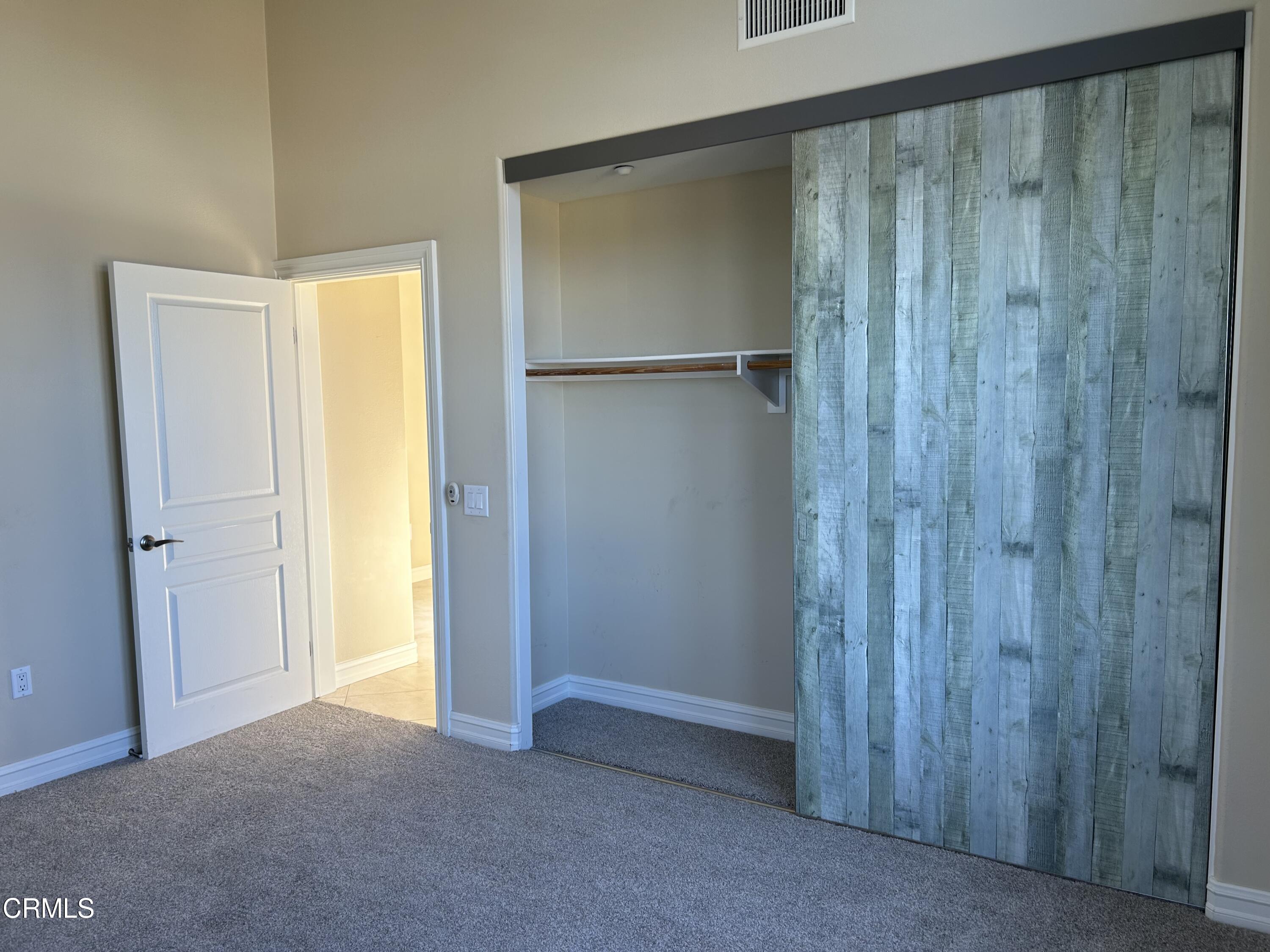 1561 Windshore Way Oxnard, CA 93035 - Photo 8 of 17 a view of an empty room with closet and wooden floor