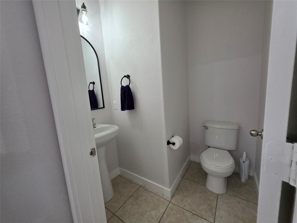 149 Ryan Street Anna, TX 75409 - Photo 9 of 38 a bathroom with a toilet and a shower