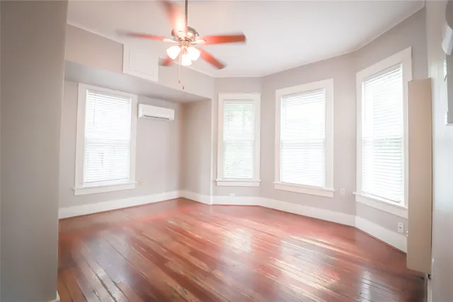 wooden floor in an empty room with a window
