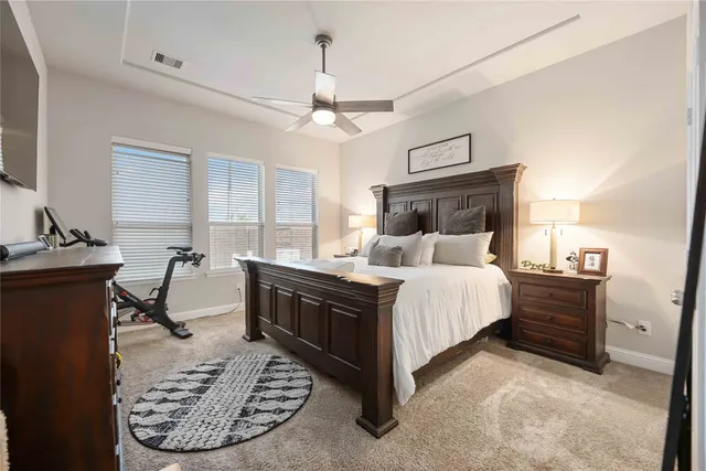 a bed room with a bed window and a chair