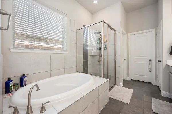 a bathroom with a tub and shower