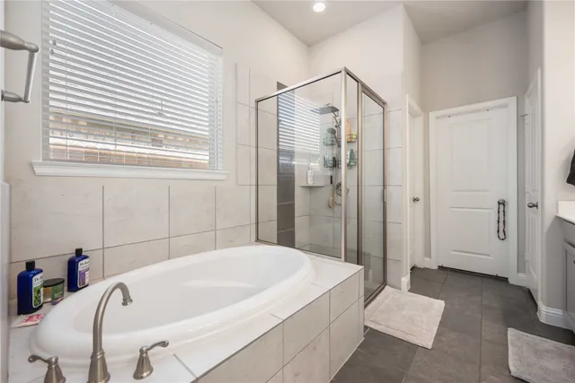 a bathroom with a tub and shower