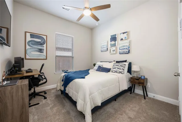 a bedroom with bed and a window