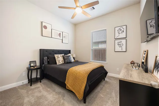 a bedroom with bed and a chandelier