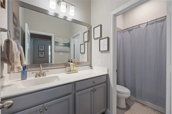 a bathroom with double sink and a mirror