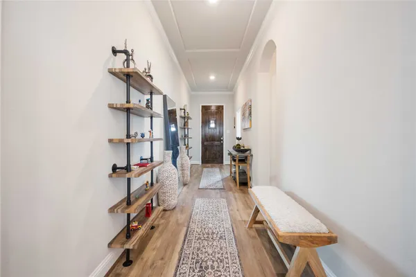 a hallway with cabinets and wooden floor