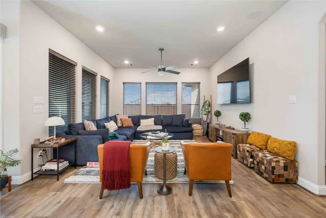 a living room with furniture and a wooden floor