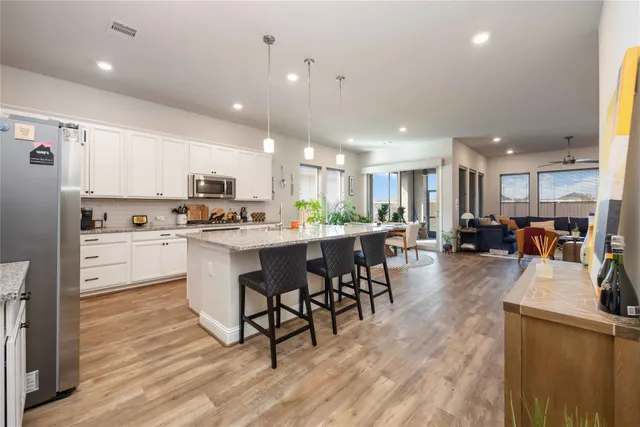 a kitchen with counter top space a sink appliances and cabinets