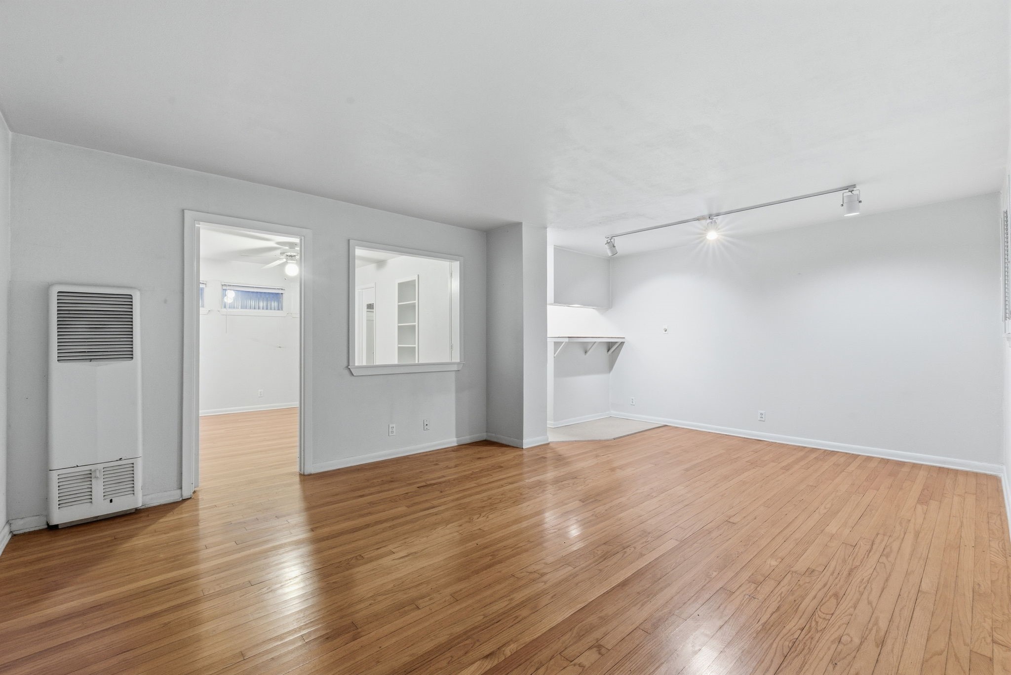 1941 Lexington Street, Unit 6 Houston, TX 77098 - Photo 17 of 50 a view of an empty room with wooden floor and a window