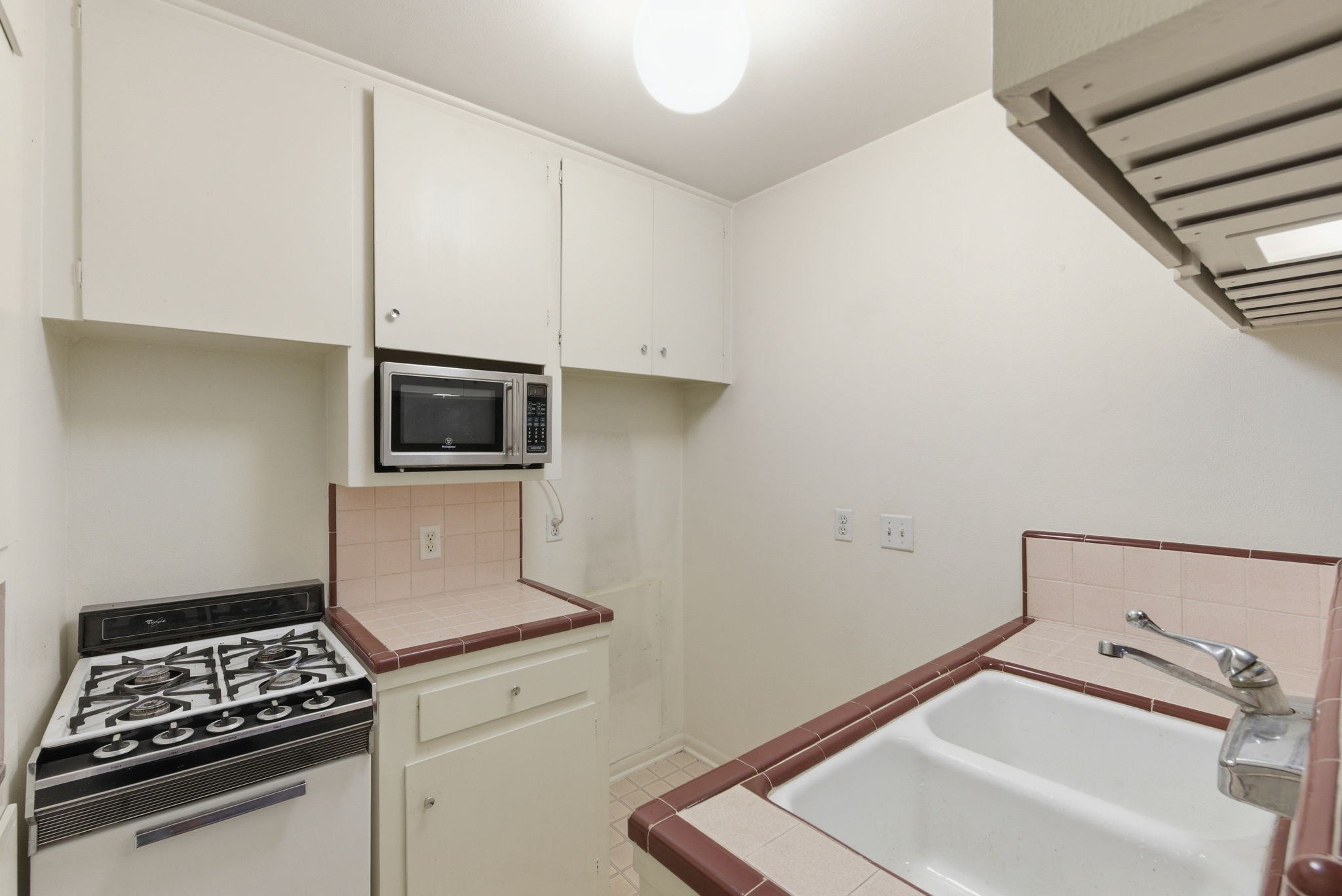 1941 Lexington Street, Unit 6 Houston, TX 77098 - Photo 35 of 50 a kitchen with a sink and a stove top oven