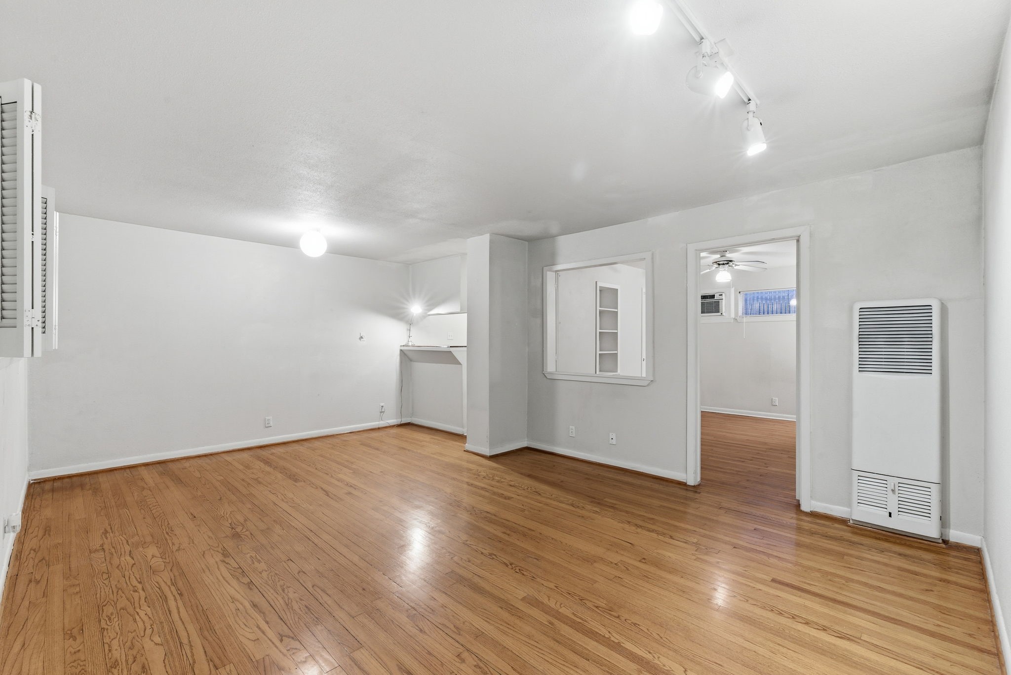 1941 Lexington Street, Unit 6 Houston, TX 77098 - Photo 9 of 50 an empty room with wooden floor & windows and bathroom