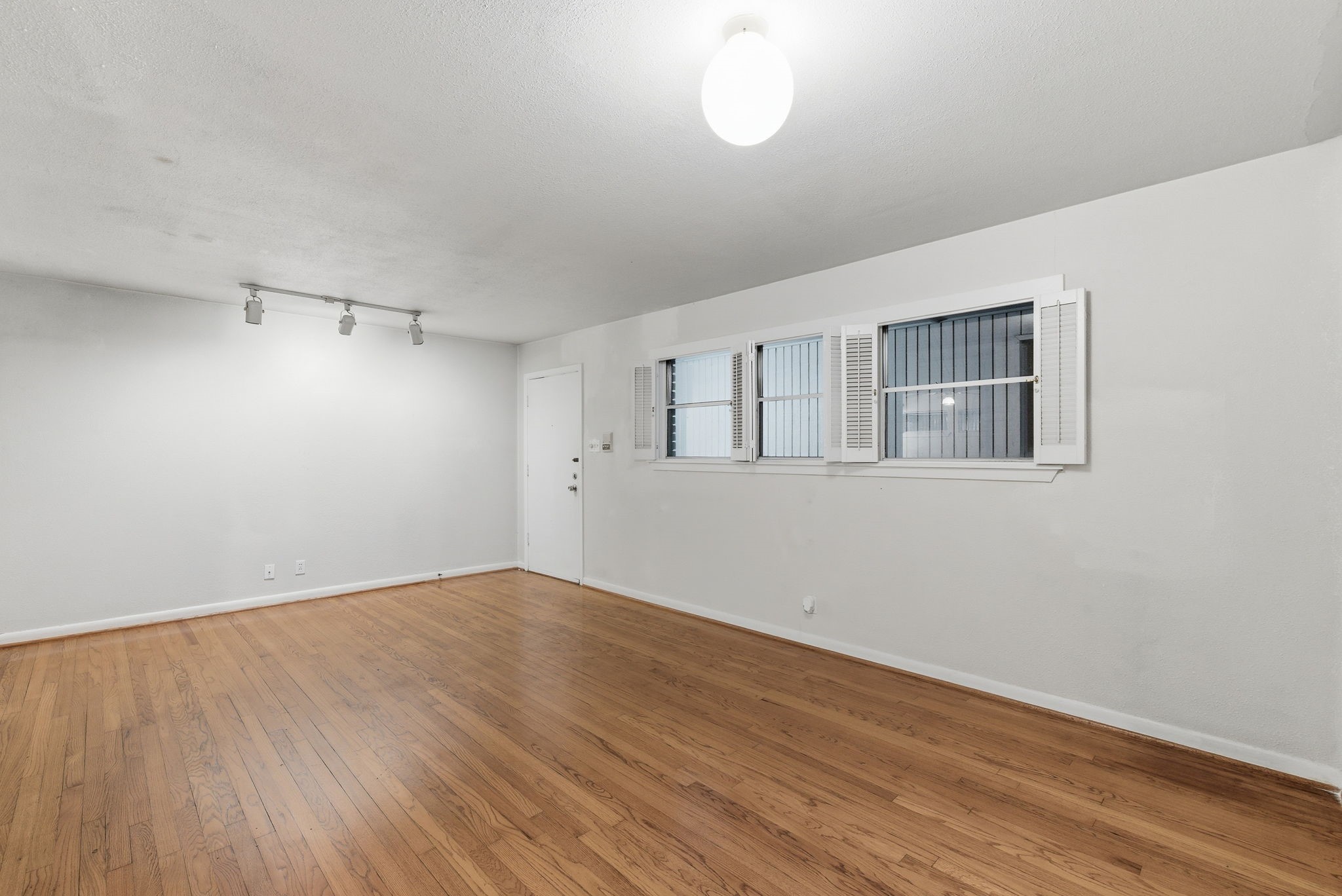 1941 Lexington Street, Unit 6 Houston, TX 77098 - Photo 10 of 50 a view of empty room with wooden floor and fan