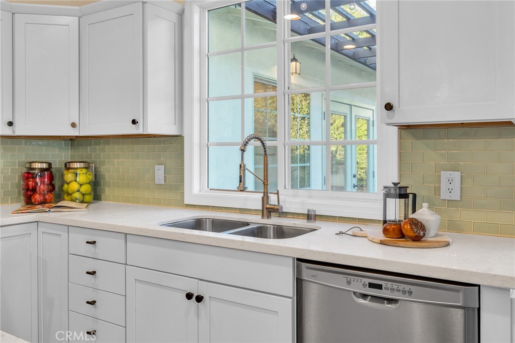 6620 Vesper Avenue Van Nuys, CA 91405 - Photo 11 of 40 a kitchen with cabinets a sink and appliances