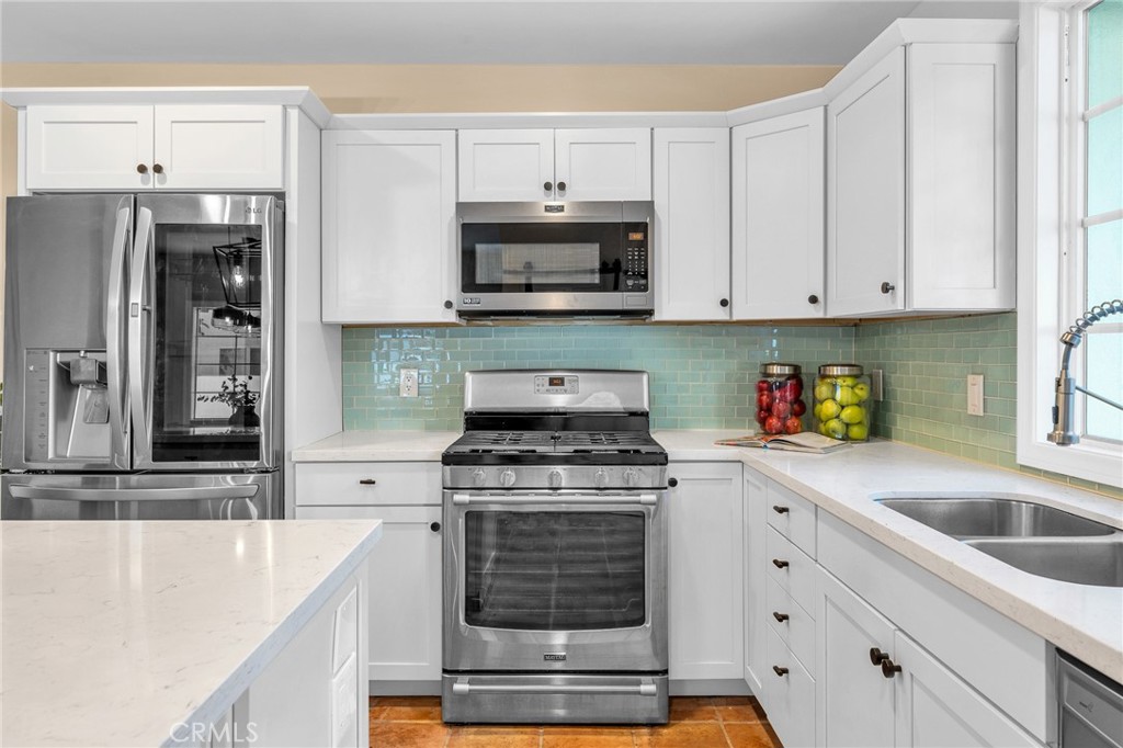 6620 Vesper Avenue Van Nuys, CA 91405 - Photo 12 of 40 a kitchen with granite countertop white cabinets and stainless steel appliances