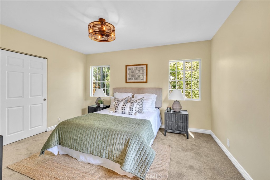 6620 Vesper Avenue Van Nuys, CA 91405 - Photo 16 of 40 a bedroom with a bed and a chair