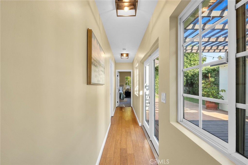 6620 Vesper Avenue Van Nuys, CA 91405 - Photo 27 of 40 a view of a hallway with wooden floor and windows