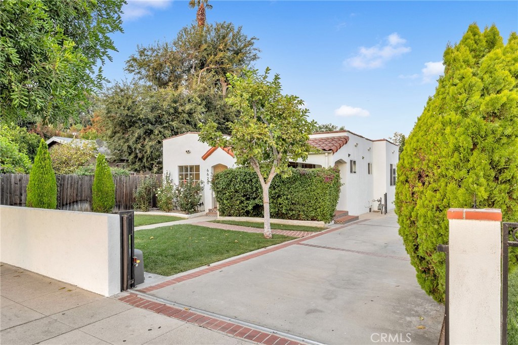 6620 Vesper Avenue Van Nuys, CA 91405 - Photo 35 of 40 a front view of a house with a yard and trees