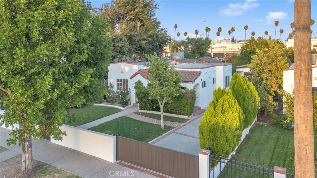 6620 Vesper Avenue Van Nuys, CA 91405 - Photo 37 of 40 a view of a house with a yard and potted plants