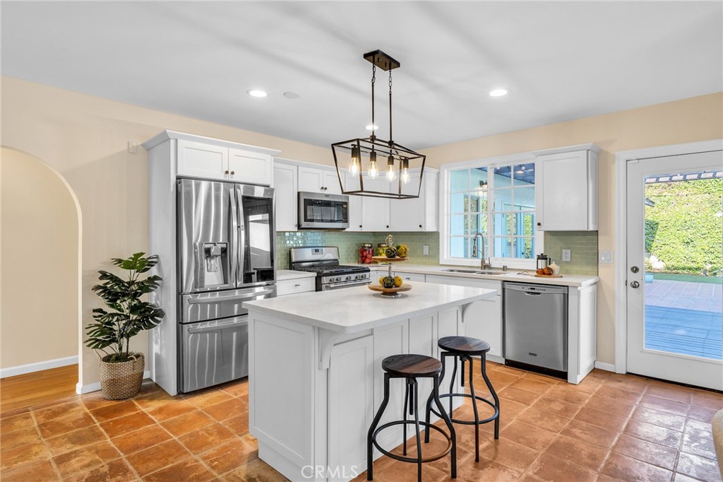 6620 Vesper Avenue Van Nuys, CA 91405 - Photo 8 of 40 a kitchen with sink a refrigerator and microwave