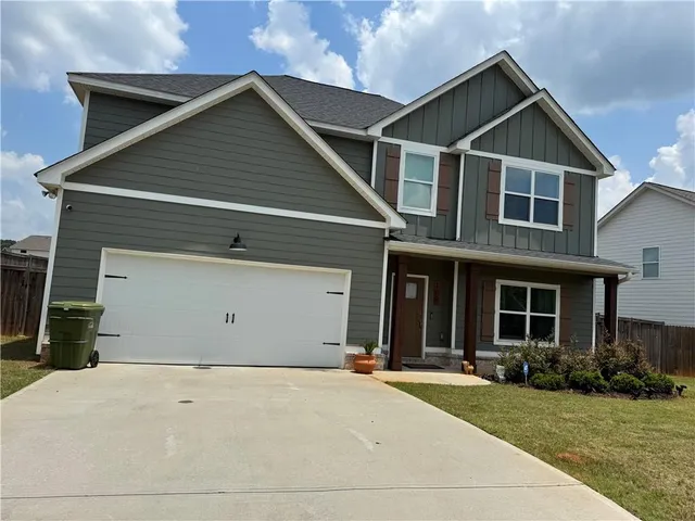 a view of a yard in front view of a house