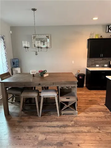 a dining room with furniture and wooden floor