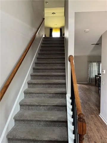 a view of entryway and hall with wooden floor