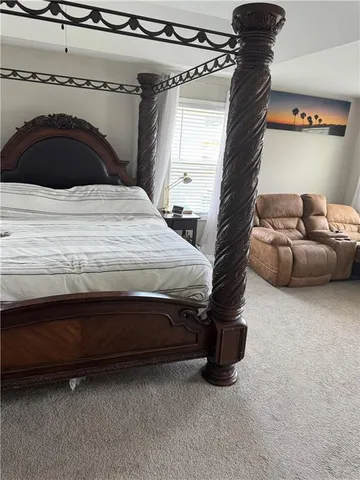 a bedroom with a bed and a potted plant