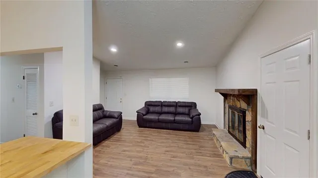 a kitchen with a refrigerator sink and wooden floor