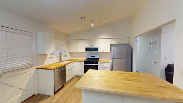 a large white bed in a white room