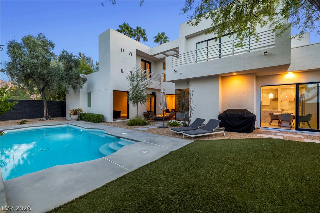 2000 Grouse Street Las Vegas, NV 89134 - Photo 53 of 89 An inviting backyard oasis features a glistening pool, lush lawn, and private patio with a fire pit.