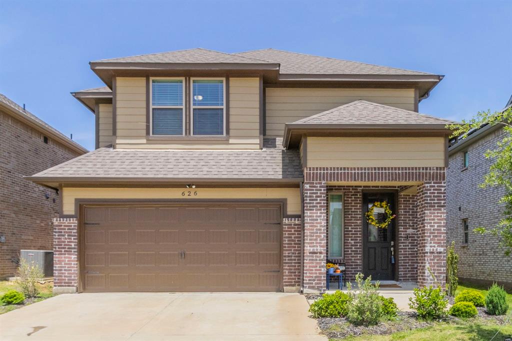 626 Ruthye Lane Pilot Point, TX 76258 - Photo 1 of 27 View of front of property featuring roof with shingles, driveway, brick siding, and a garage